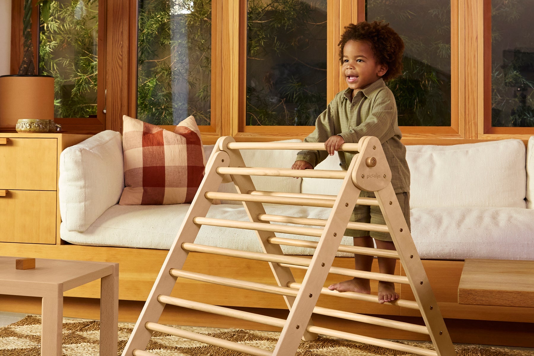 Child climbs a Pikler Triangle made of non-toxic wood