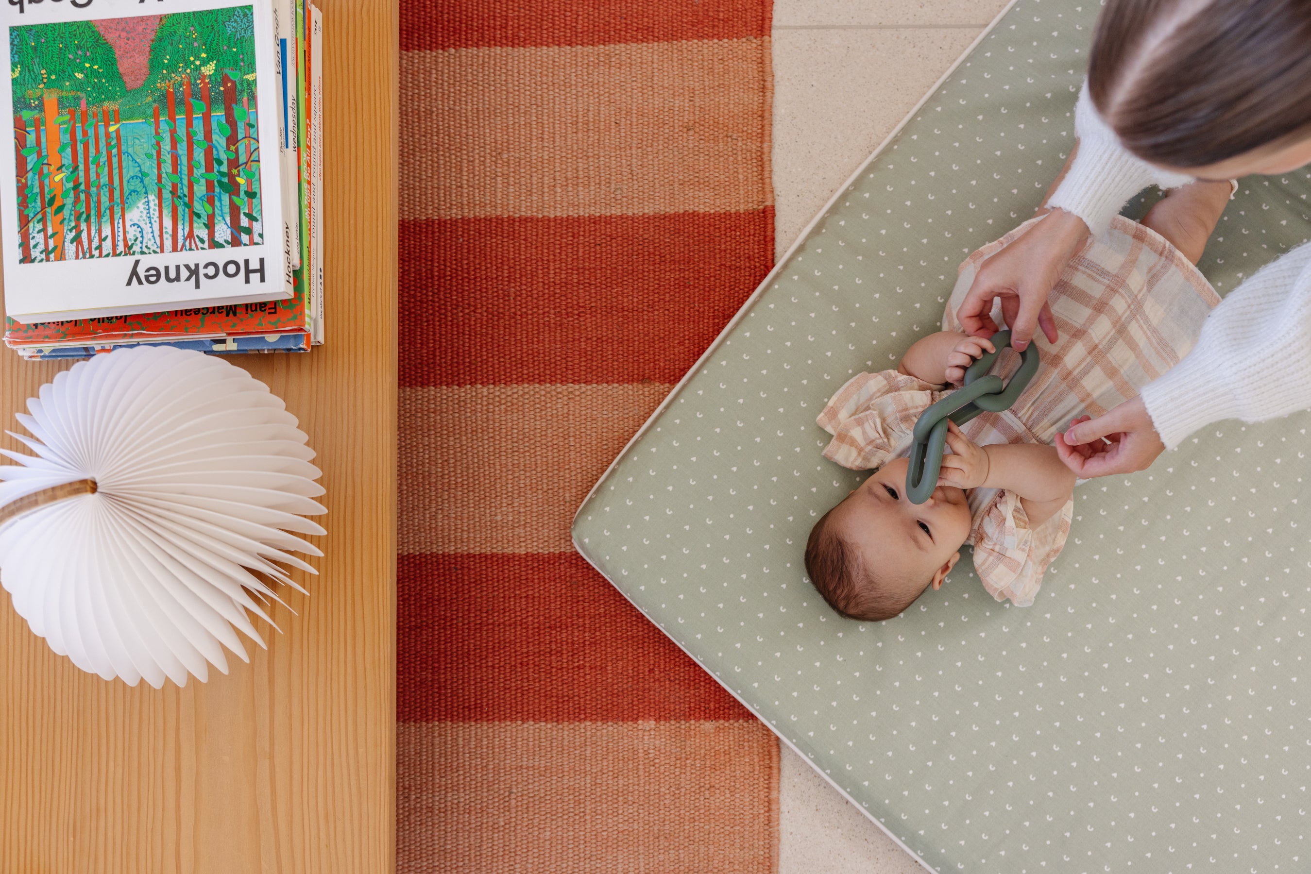 baby playing on the baby play mat with toys