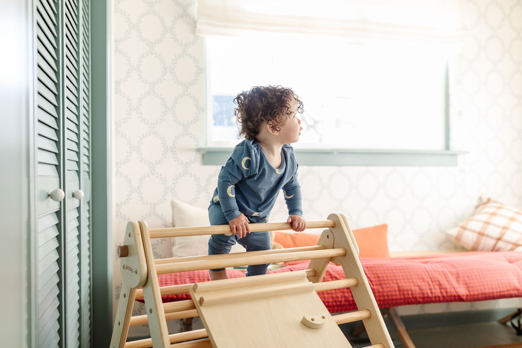 boy climbing on the pickler triangle