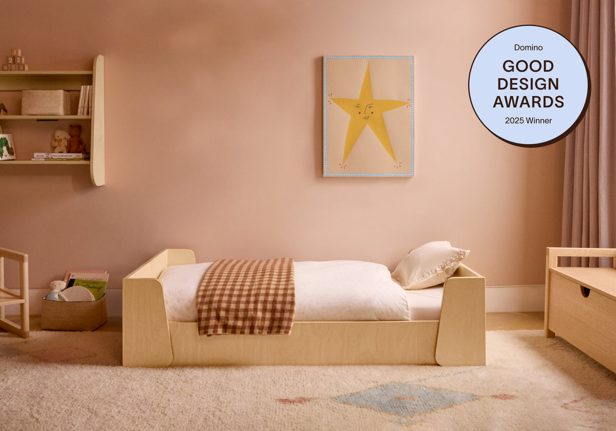 Piccalio Montessori floor bed in the toddler size set up in a child's room. The bed won a Domino Good Design Award