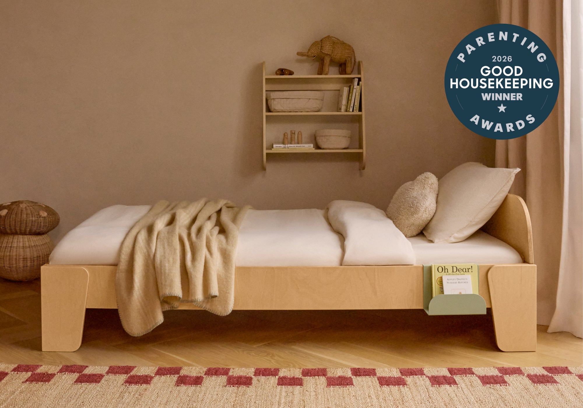 The Piccalio bedBED, crafted with natural wood and set up a headboard and book hook in a child's room. bedBED won a Good Housekeeping Parenting Award in 2026