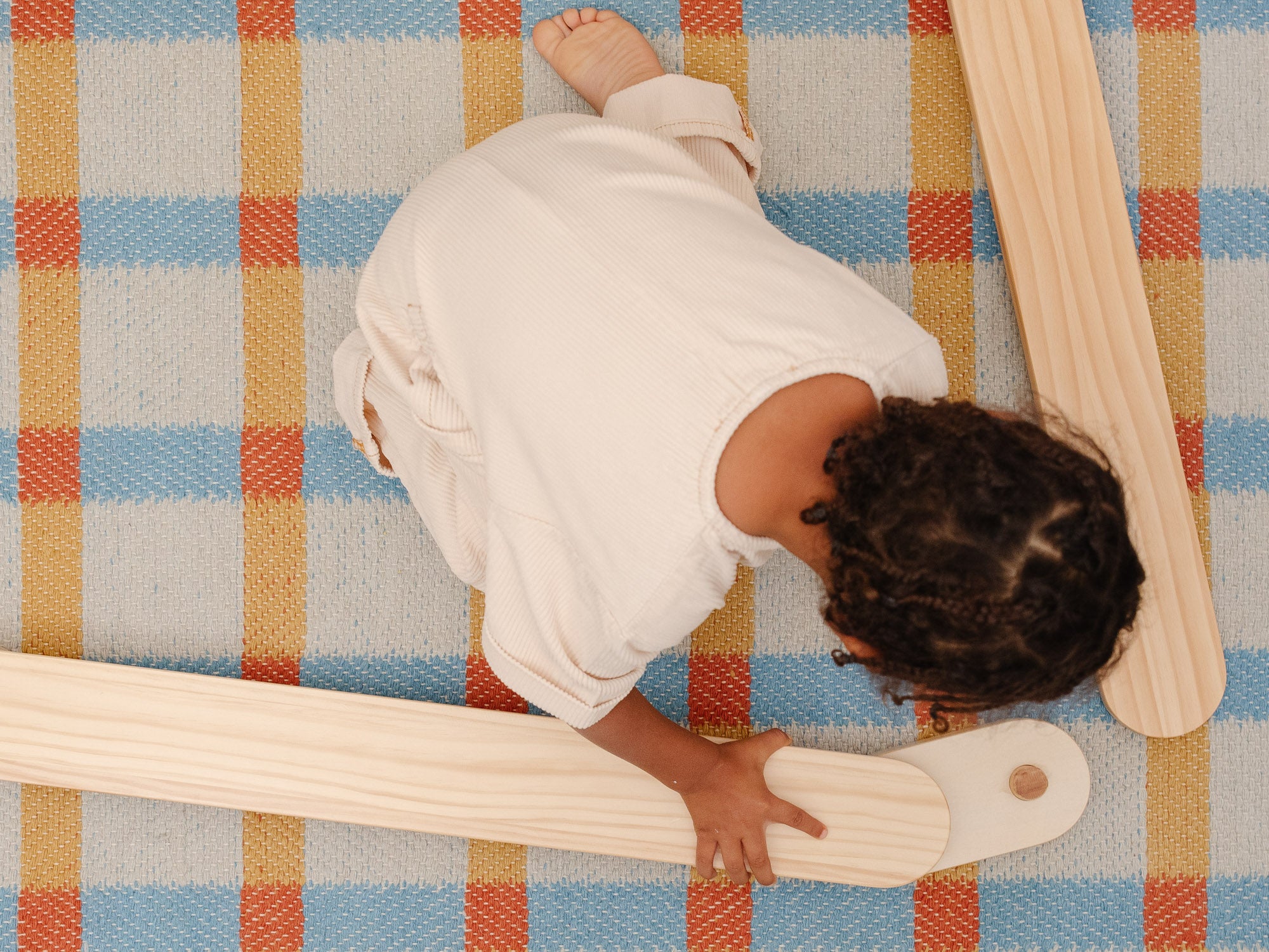 wooden balance board and a toddler playing