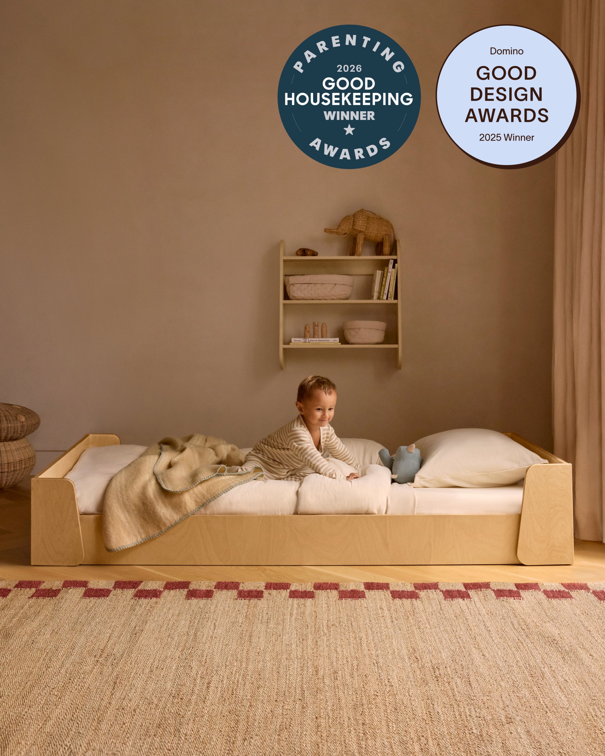 Piccalio Montessori bed in natural wood twin size with a child lying in the bed.