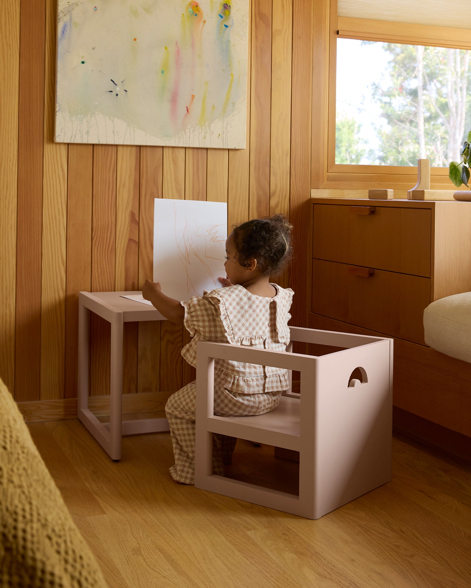 Toddler girl drawing at a pink Piccalio Montessori activity table and kids chair.