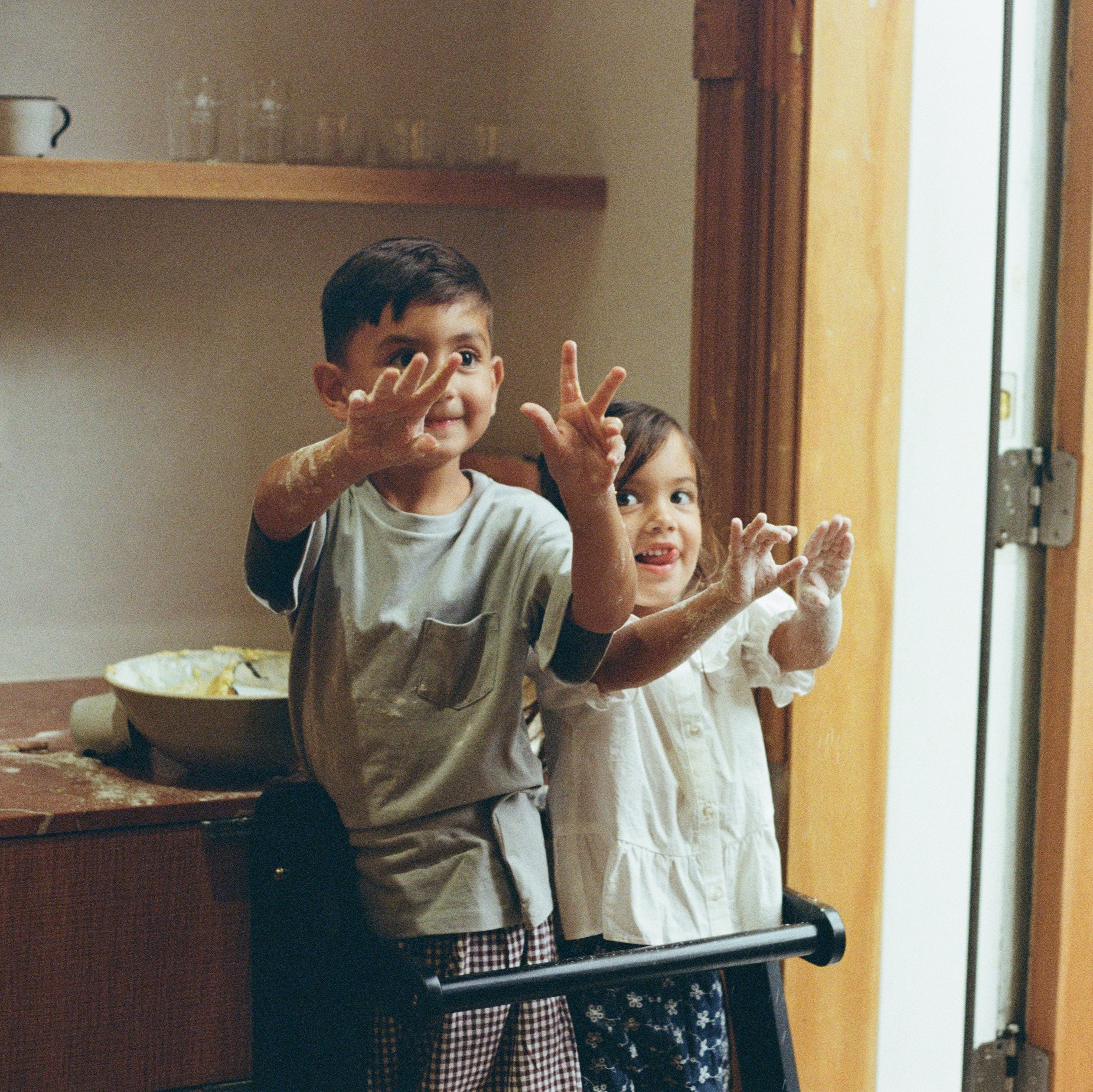 Piccalio Foldable Toddler Tower with two toddlers in a kitchen standing on the toddler.