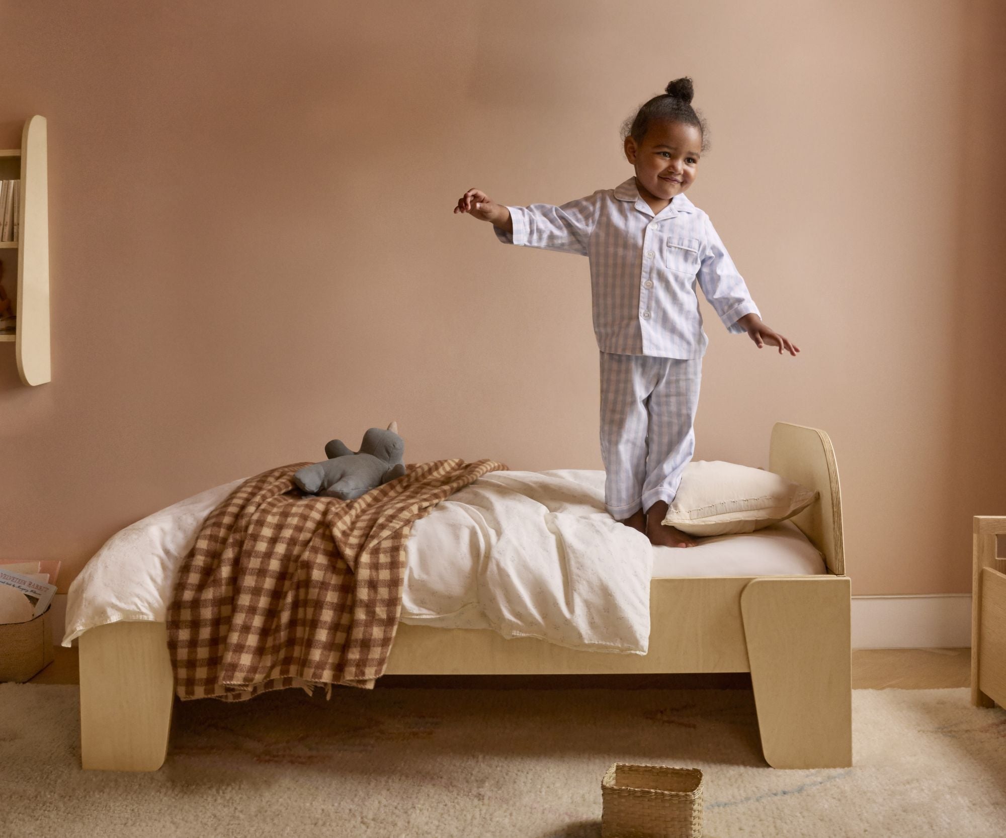Toddler standing on bed, When to Transition from Crib to Bed, when to move from crib to bed