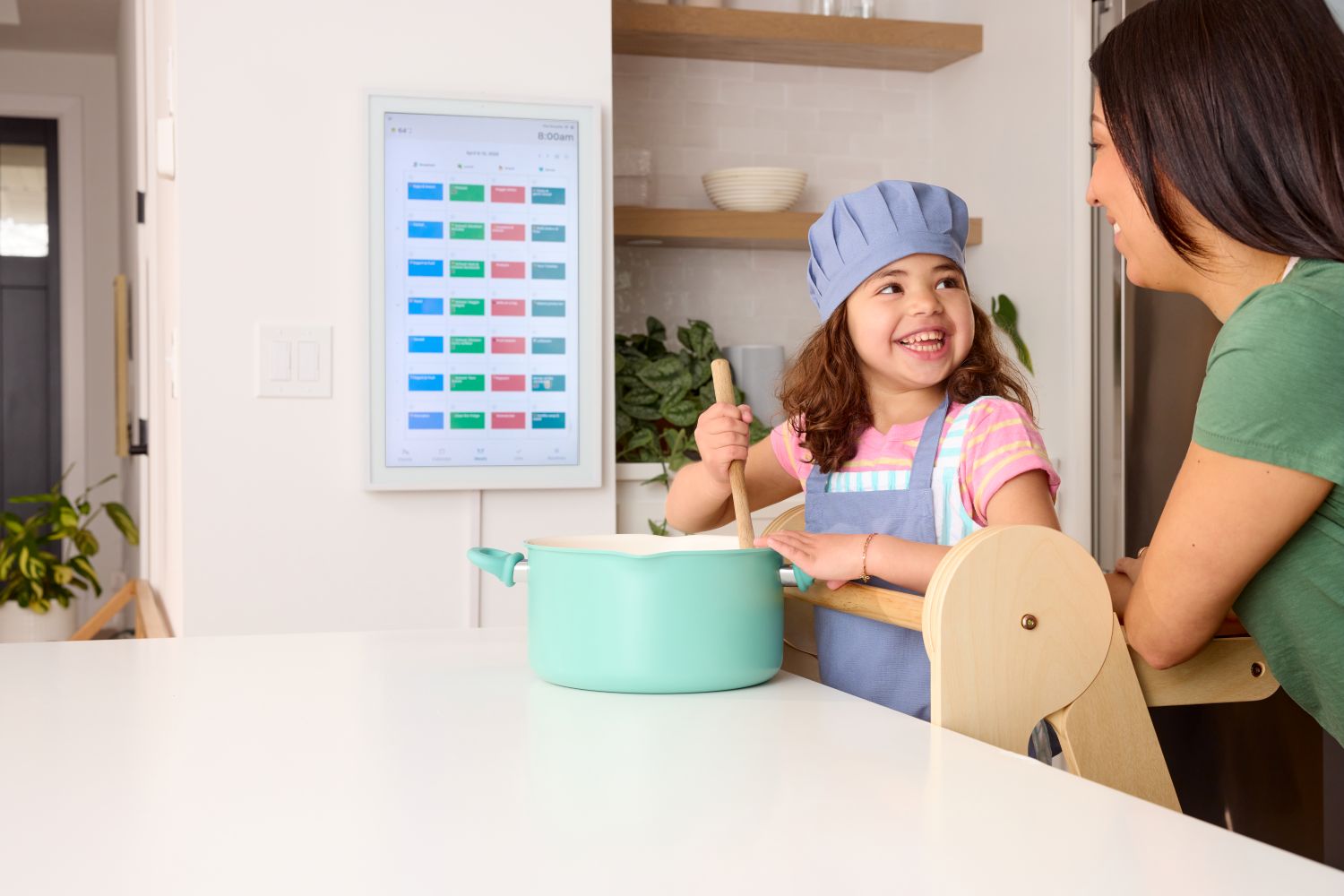 Child using a Foldable Toddler Tower with the Hearth Display in background