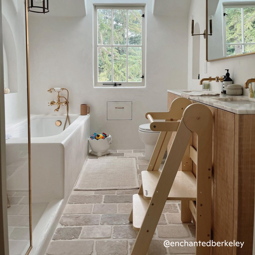 Foldable learning tower made of natural wood in the bathroom