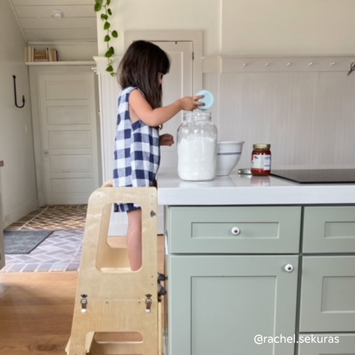 Child pouring flour using convertible Piccalio learning tower