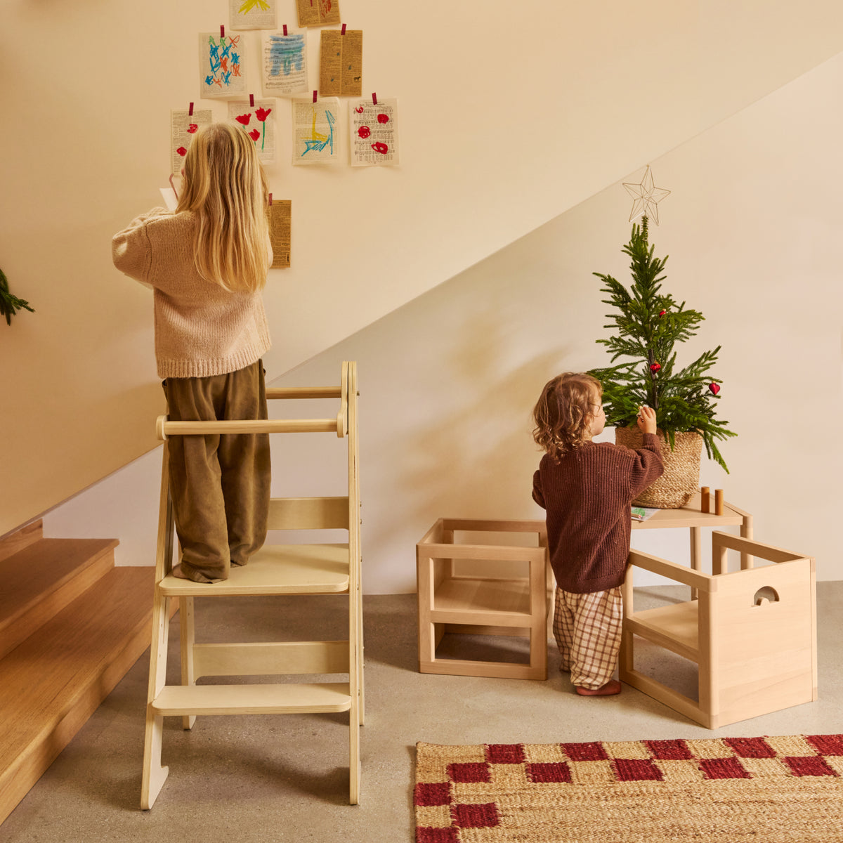 Children use the Piccalio Foldable Toddler Tower and Toddler table and chair set to decorate for Christmas