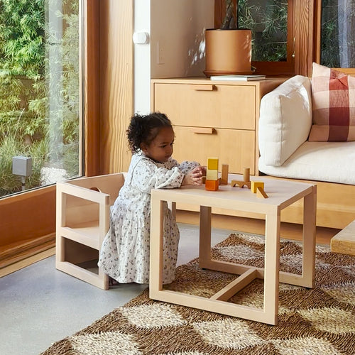 Toddler playing with blocks at the Piccalio Montessori weaning table and chair set in natural beech wood