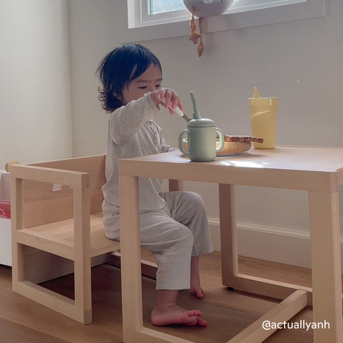 Toddler eating at the Piccalio Montessori weaning table and chair set in natural beech wood with a non-toxic finish