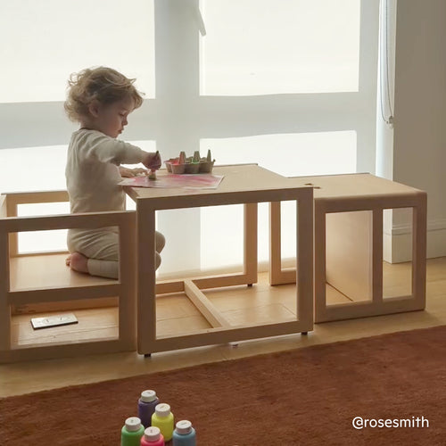Toddler paints at the Piccalio toddler table and chair set in natural birch wood