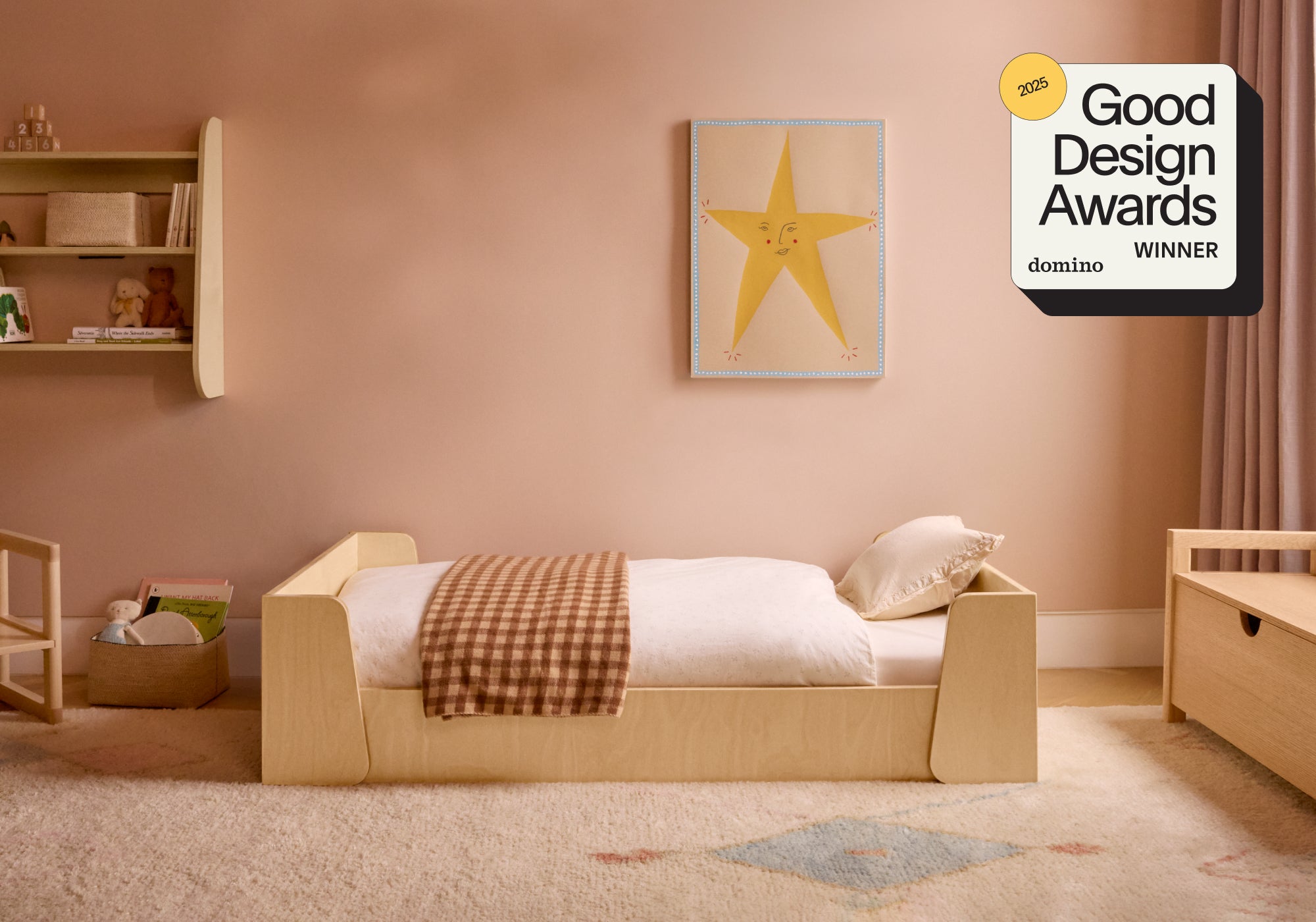 Piccalio Montessori floor bed in the toddler size set up in a child's room. The bed won a Domino Good Design Award