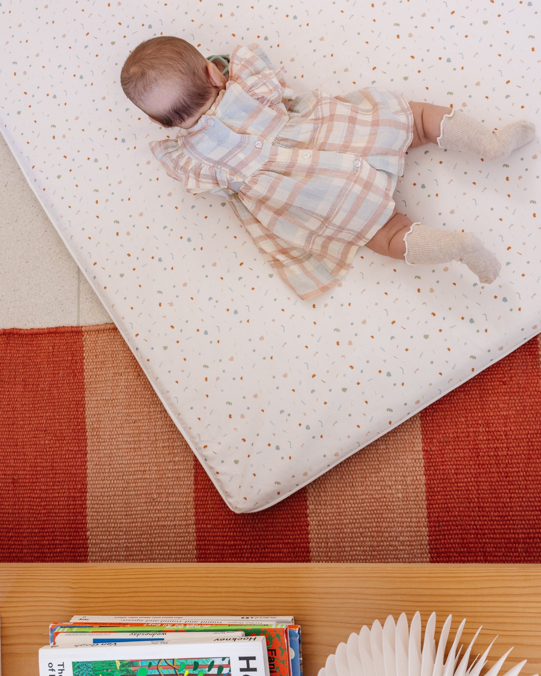 Baby at tummy time on the Piccalio organic cotton play mat.