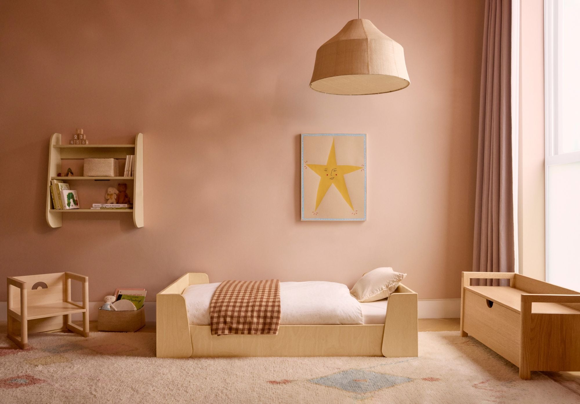 A styled children's bedroom featuring the Piccalio Montessori floor bed made of natural wood.