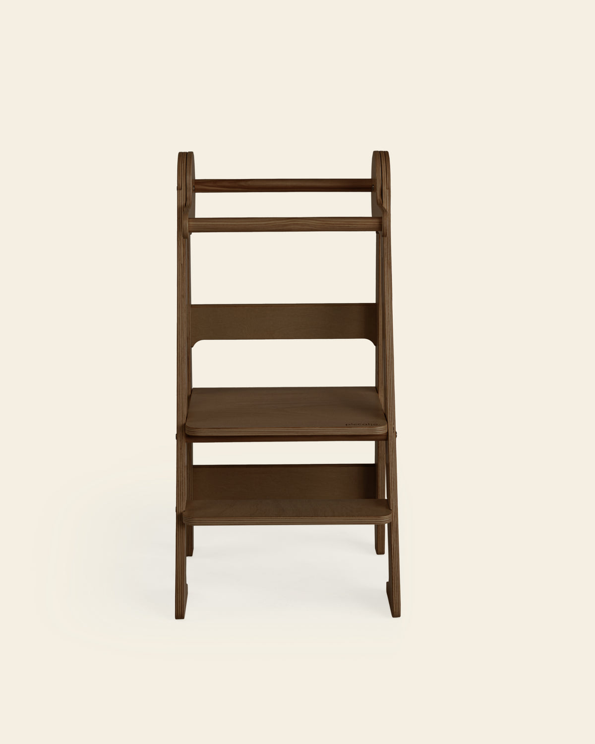 A front view of the Piccalio Foldable Toddler Tower in a walnut stain, designed to support independence in toddlers.
