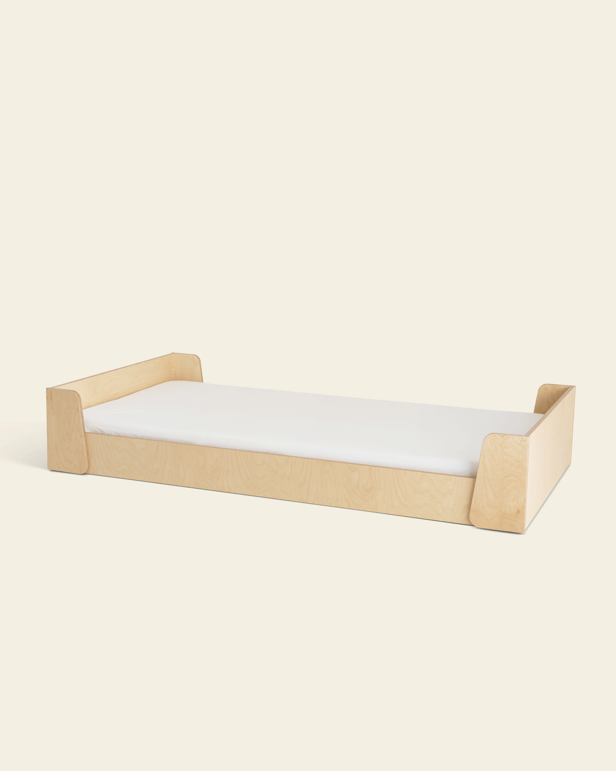 Piccalio Montessori floor bed in natural wood for toddler independent sleep.