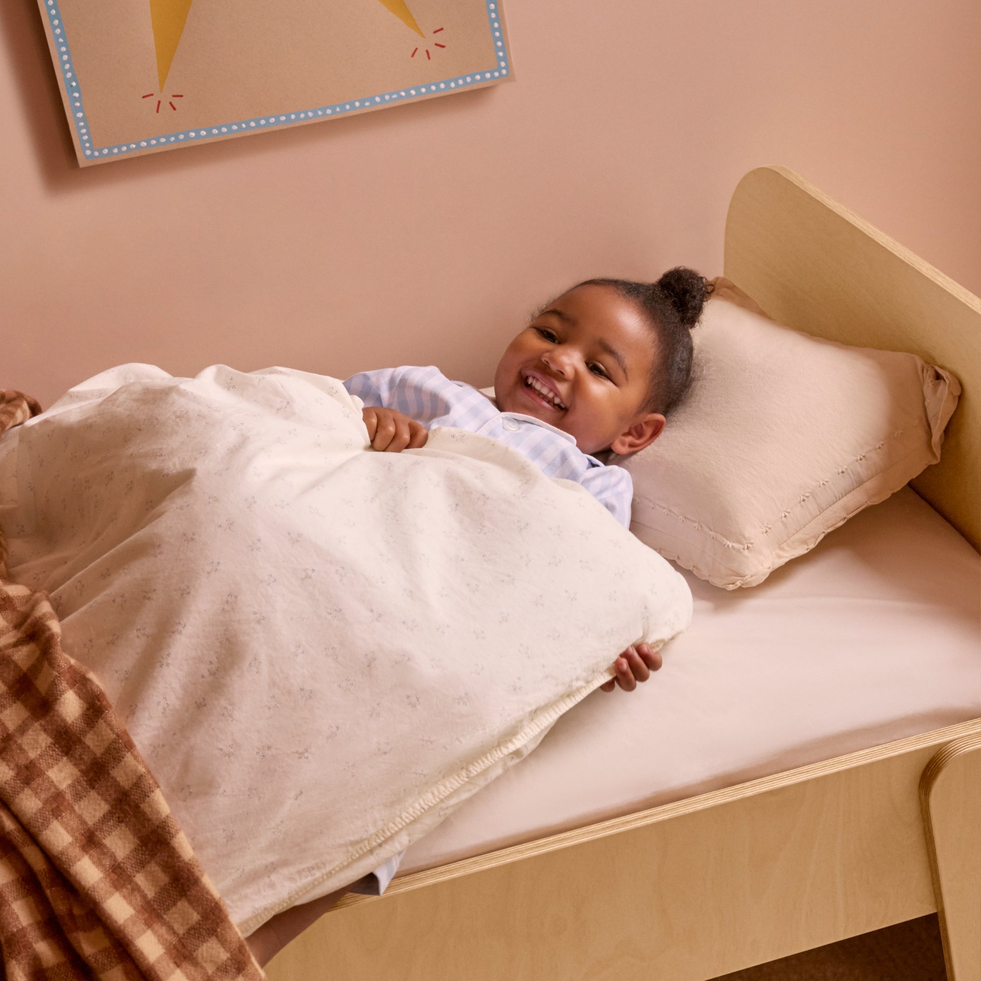 Piccalio Montessori toddler floor bed with headboard for a safe transition from crib to big kid bed.