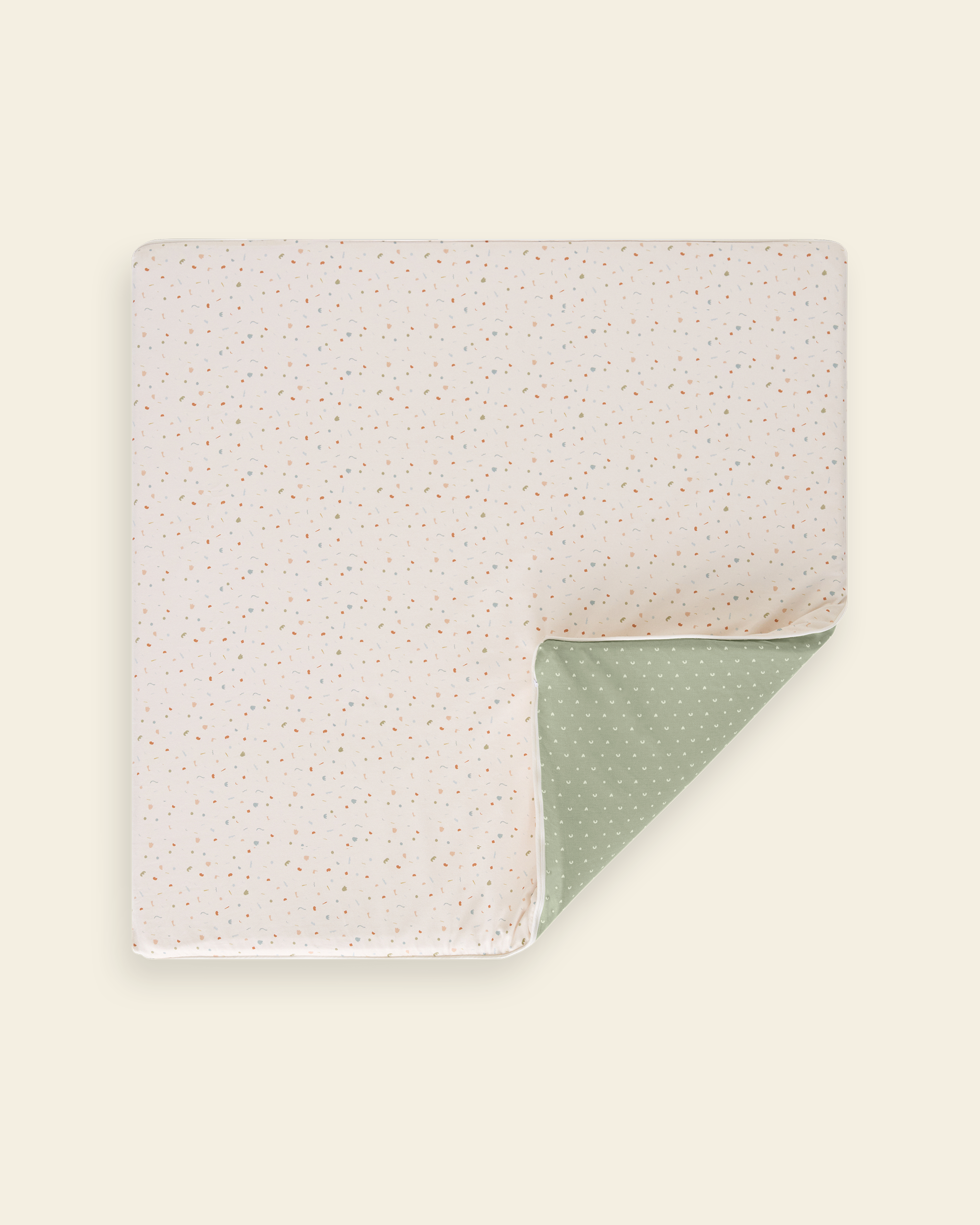 Piccalio non-toxic padded baby play mat with a confetti-style pattern on one side and a sage green geometric print on the other.
