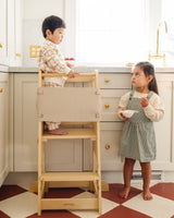 boy and a girl on a educational platform tower in the kitchen
